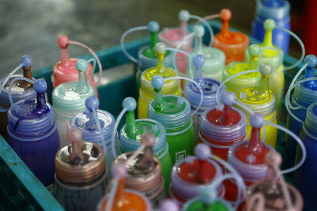 Colorful plastic bottles with paint and brushes for painting in the marketの写真素材