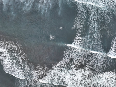 Aerial view of the waves crashing on the shore of the Atlantic Ocean.