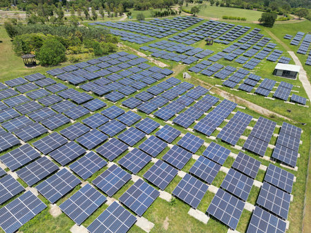 Aerial view of solar power plant with many rows of solar panels