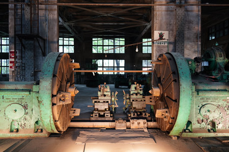 A massive vintage wheel lathe machine in a historic railway workshop museum.