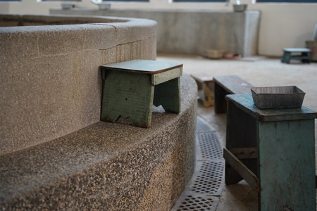 Old wooden stools and washing items at the historic employee bathhouse in the Taipei Railway...