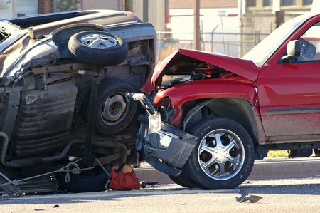 Two cars smashed together in a car accident with rolloverの写真素材