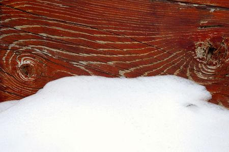 Detail of snow and old weathered wood painted redの写真素材