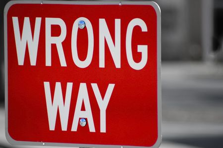 Red street sign stating wrong way directionの写真素材