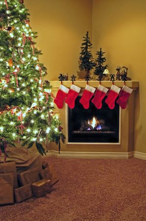 Front room decorated for christmas with christmas tree stockings and fireplaceの写真素材
