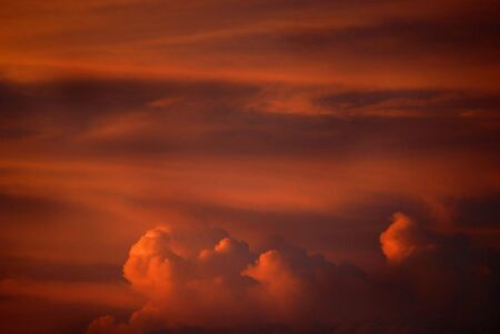 Sunset thunder storm clouds in orange and golden light