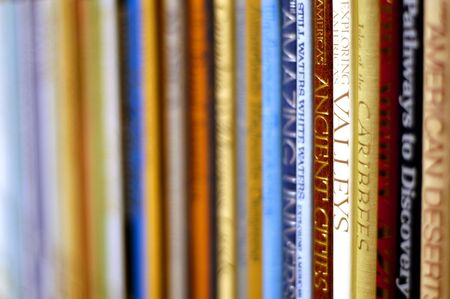 Row of colorful books on a shelfの写真素材