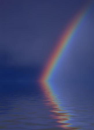 Colorful bright rainbow set against stormy sky with reflectionの写真素材