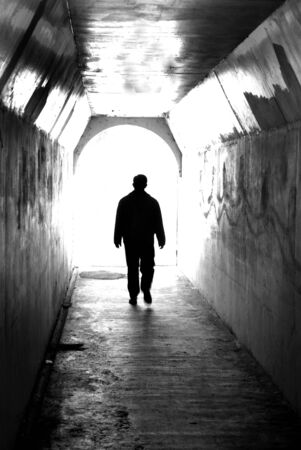 Long tunnel walkway with person at the endの写真素材