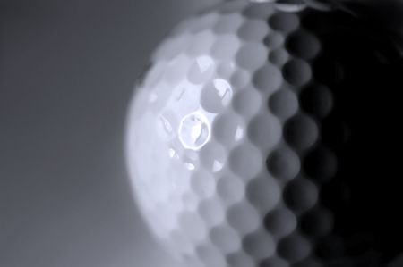 Closeup of golfball with dark shadows の写真素材
