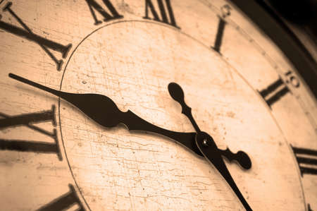 Detail of clock face with numbers and hands showing timeの写真素材