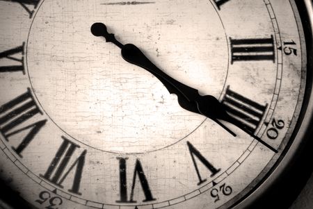 Detail of clock face with numbers and hands showing time