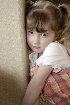 Little girl in a dress making faces expressionsの写真素材