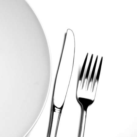 Knife and fork silverware with white plate on white backgroundの写真素材