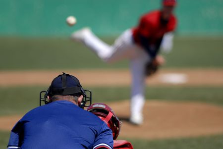 Baseball player wearing uniform throwing baseballの写真素材