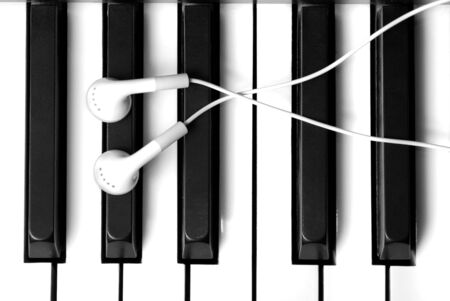 Piano keys black and white with earphones on topの写真素材