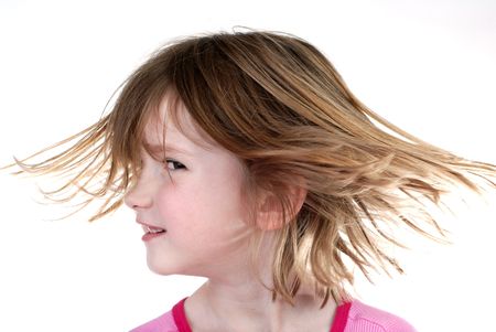 Young girl with surprised look holding hands on faceの写真素材