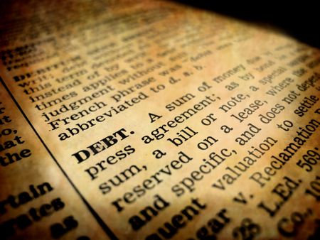 Definition of debt in dictionary book on pages with typeの写真素材