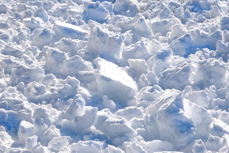 Crust of frozen pile with clumps of snowの写真素材