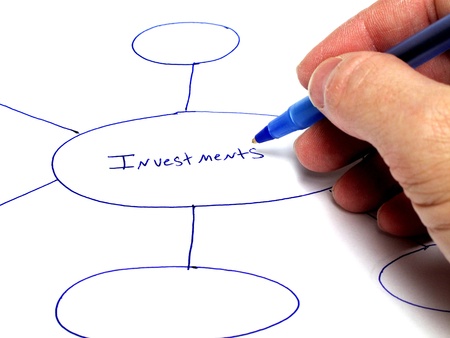 Person writing notes on paper about plans for investmentsの写真素材