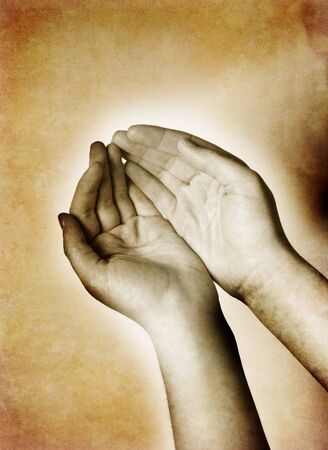 Hands cupped together with antique sepia backgroundの写真素材