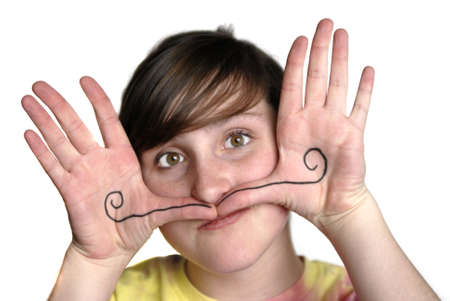 Young girl with mustache drawn on hands silly faceの写真素材