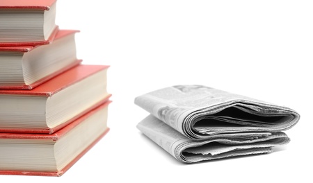 Stack of red books and newspapers isolated on white background