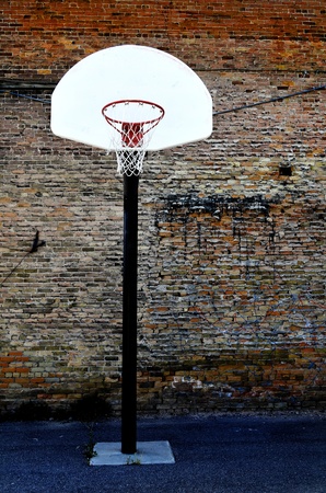 Urban basketball court in neighborhood with old buildings            の写真素材