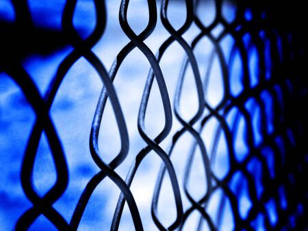 Chain Link Fence on Border Keeping People in and Outの写真素材