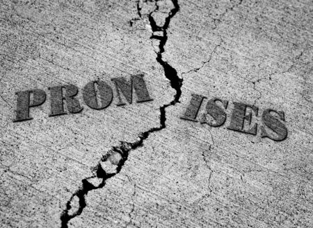 Broken promises with crack in concrete with wordsの写真素材