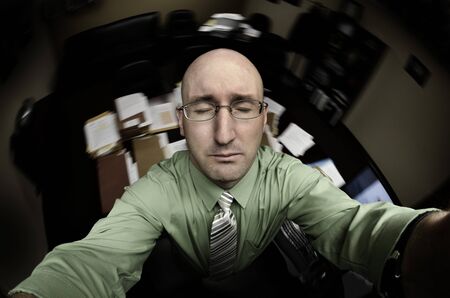 Business Man in Office Praying for Helpの写真素材