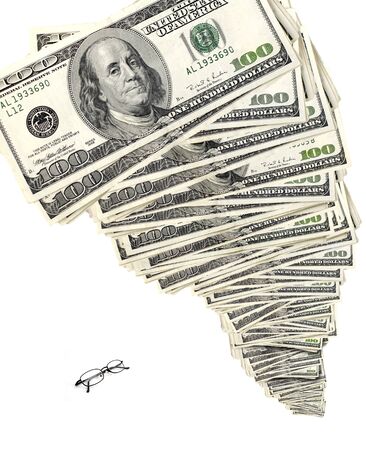Tower of cash and bills with small glasses down belowの写真素材