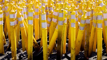 Pile of yellow caution cones used in road constructionの写真素材