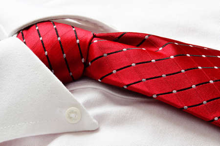 Closeup of white shirt and red tie with copy space