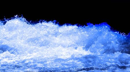 Wave of water isolated on blackの写真素材