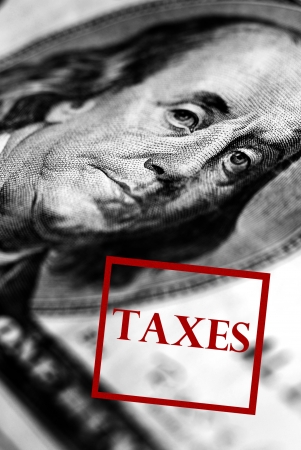 Closeup of hundred dollar bill with taxes stamped across bottomの写真素材