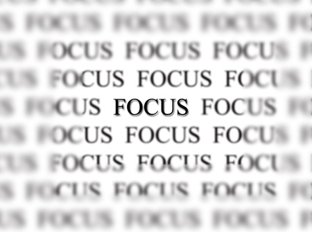 The word focus with blurred words in background isolated on white as concept for business ideasの写真素材