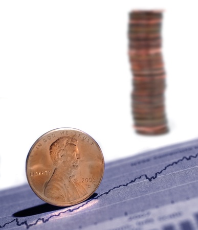 Closeup of pennies with graph and stock chart in backgroundの写真素材