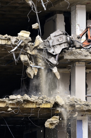Building collapsing or being demolished with debris falling downの写真素材