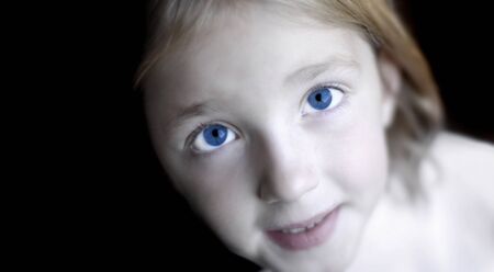 Portrait of young little girl with focus on eyesの写真素材