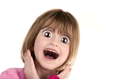 Young girl with surprised look holding hands on faceの写真素材