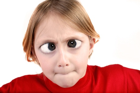 Little girl wearing red shirt isolated on white making funny faceの写真素材