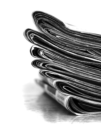 Piled up newspaper isolated on white backgroundの写真素材