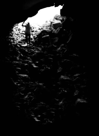 Long dark cave with person at the endの写真素材
