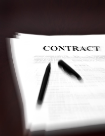 Contract on desk with black pen waiting to be signedの写真素材