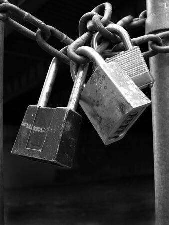 Several Locks and chain on fence gate for security