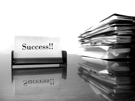 Business card on desk with files and word Successの写真素材