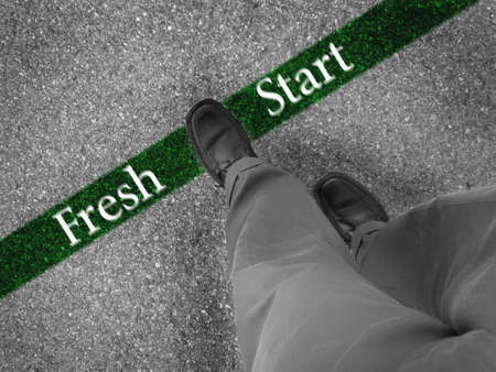 Man walking across a green line with words fresh startの写真素材