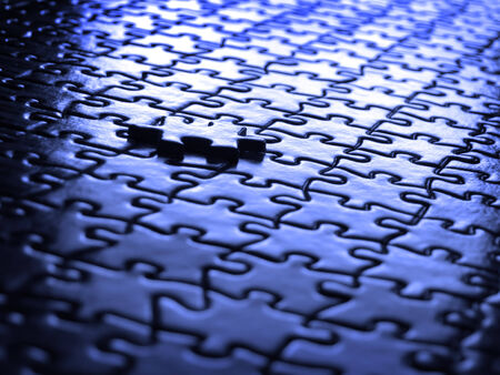 Several puzzle pieces put together symbolizing success and completion of a projectの写真素材