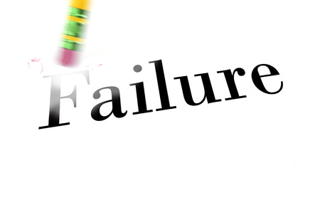 Person using a pencil eraser to erase failure from their life so they can start newの写真素材